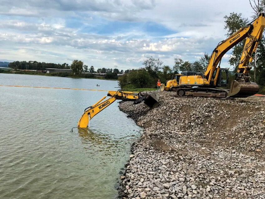 An excavator sits submerged in a pond at the Port of Longview after a slope collapsed Sept. 8 on a Rotschy construction site. The company&rsquo;s safety history has come under scrutiny after two workers suffered severe injuries while working for the company.