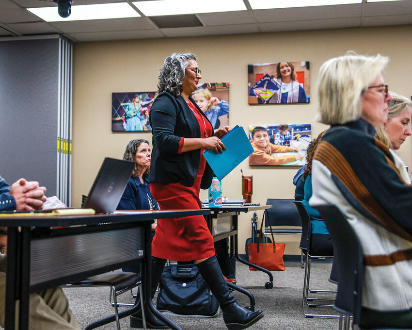 Battle Ground Education Association President Mary Mendoza-Haensel walks to the podium to provide a public comment during the Monday, Oct. 13, Battle Ground Public Schools board meeting.