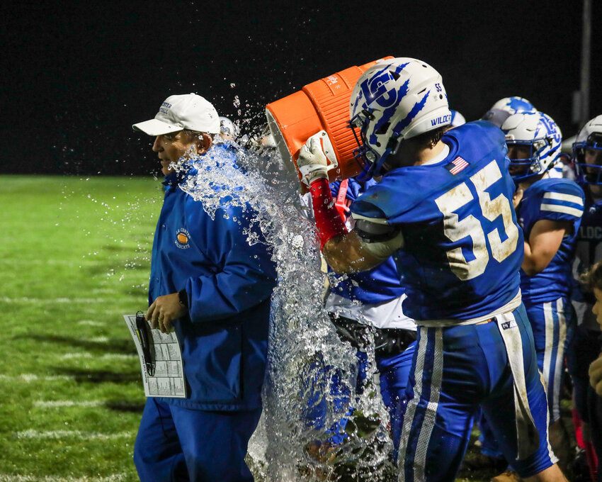 La Center&rsquo;s Mason Klein dumps water on Wildcats&rsquo; head coach John Lambert in celebration as Lambert earned his 200th career win as head coach as his Wildcats beat the Kalama Chinooks 42-16 on Friday, Oct. 24.