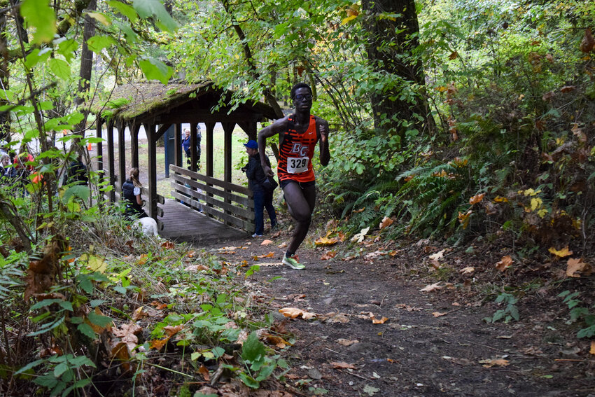 Lord King Nana-Badu-Weah runs up a hill during the boys' race at Lewisville Park on Wednesday, Oct. 22. The Battle Ground junior finished second overall with a time of 15:44.