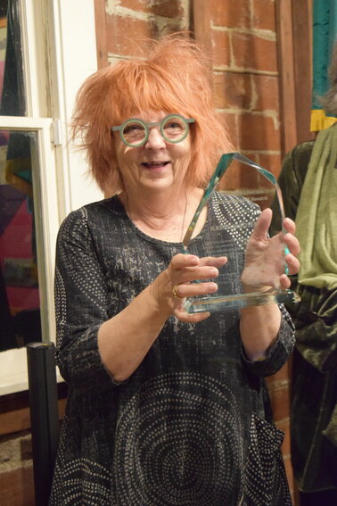 Karen Madsen holds the Clark County Arts Commission&rsquo;s 2025 Lifetime Achievement Award during an Oct. 21 ceremony at the Clark County Historical Museum. The award honors her decades of leadership in building the region&rsquo;s creative community.