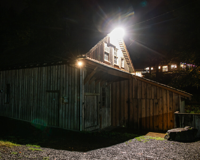 The Cedar Creek Grist Mill is illuminated at night by a single light during a sprinkly night on Saturday, Oct. 11, where the Big River Paranormal investigation team conducted an exercise.