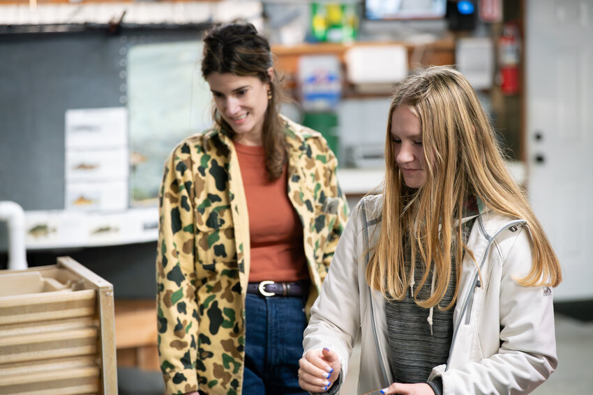 Rep. Marie Gluesenkamp Perez, D-Skamania, watches an Onalaska High School student feed a fish on Tuesday, Oct. 28.