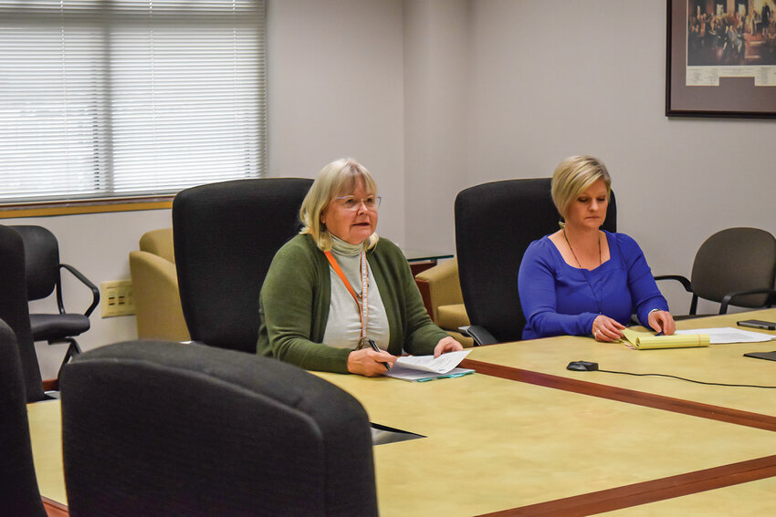 Clark County Council Chair Sue Marshall, left, and Contract Administrator DeAnn Cordes, right, listen during the Oct. 30 EMS District 2 board meeting. The board unanimously approved higher ambulance rates for 2026 after Vancouver withdrew from the regional contract.