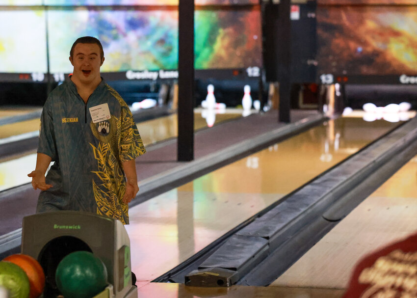 Battle Ground Special Olympics athlete Hezekiah Hewes celebrates his first strike of his career-best 152 during a sub-regional bowling event at Crosley Lanes on Oct. 19.