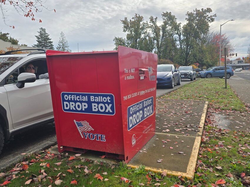 Voters deposit ballots into the Battle Ground Clark County ballot drop box on Election Day, Tuesday, Nov. 4. Early results show some close races across north Clark County