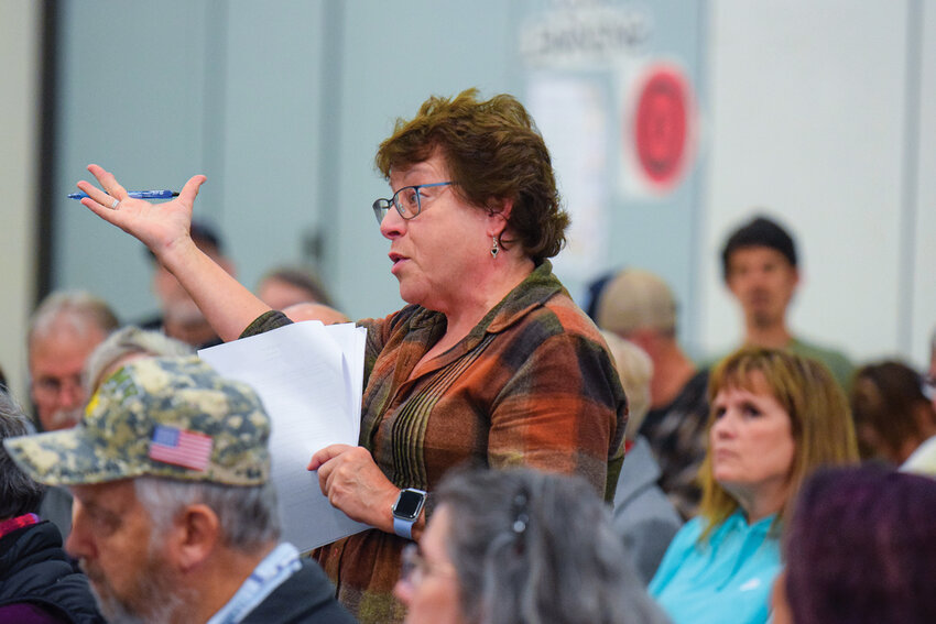 A resident raises a question during the Nov. 8 forum at Yacolt Primary School. Many attendees voiced concerns about fire danger, eminent domain, and the potential loss of trees and property value.