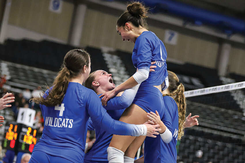 La Center's Paige Sherry lifts Annicka-May Fagerlie in celebration against Cascade Christian in the 1A State Volleyball Tournament quarterfinals at Yakima Valley SunDome on Friday, Nov. 14.