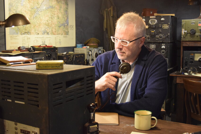 Craig McCourry sits at the position where his main character will operate a radio to communicate with the film&rsquo;s artificial intelligence. The scene is central to &ldquo;The Singularity Protocol,&rdquo; which explores human-machine communication through a historical lens.