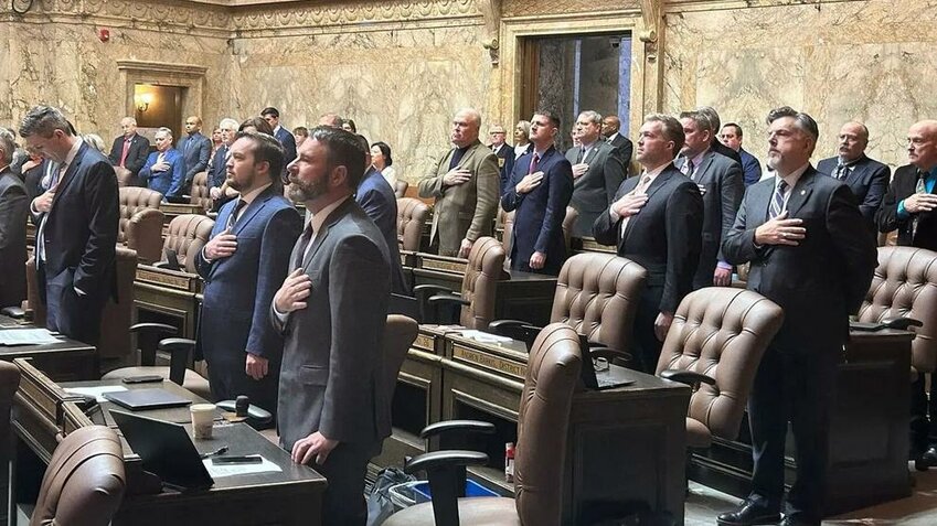 Washington lawmakers recite the Pledge of Allegiance on opening day of the 2024 legislative session in Olympia.