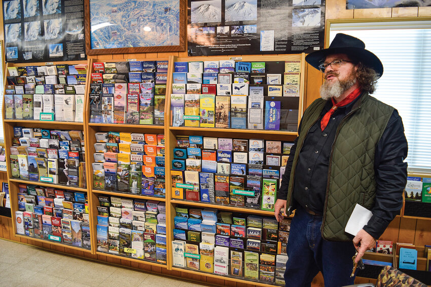 Chamber Executive Director Keith Bellisle shows pamphlets that passersby can take on the wall inside the Visitor Center. The facility may close in January without at least $40,000 from the City of Woodland&rsquo;s LTAC funds.