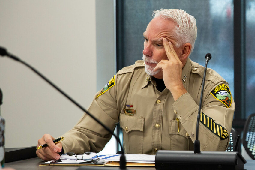 Lewis County Sheriff Rob Snaza listens closely to oth3er members of the board during the Lewis county 911 executive board meeting on Wednesday, Nov. 19.