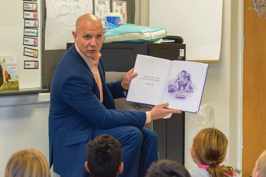 Rep. Peter Abbarno reads &ldquo;Our Table&rdquo; to a second-grade class during his visit to South Ridge Elementary on Wednesday, Nov. 19. The reading was part of his full-day shadowing of Principal Tawny Malone as the school prepares for changes tied to the district&rsquo;s new elementary configuration.