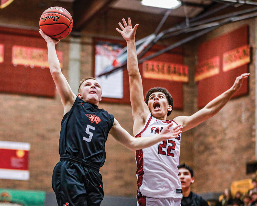 Battle Ground junior Benjamin Reck races Prairie defender Daniel Carbajal-Vargas for a lay-up score during the Tigers&rsquo; 104-54 loss to the Falcons on Tuesday, Dec. 2.