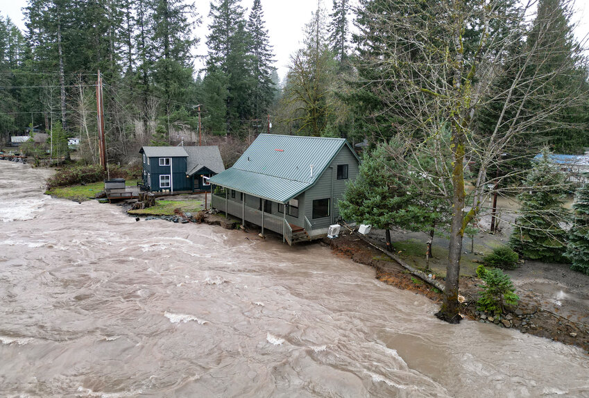 The Cowlitz River runs against the edge of homes off of Slalom Way in Packwood on Thursday, Dec. 11.