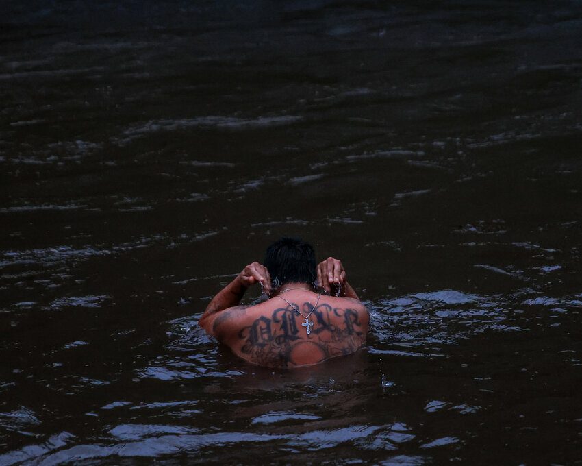 Battle Ground resident Shane Black&rsquo;s cross necklace and Navajo tattoo reading &ldquo;Din&eacute;&rdquo; is visible while he practices a cold water plunge in the East Fork Lewis River on Monday, Dec. 8, at Daybreak Regional Park.