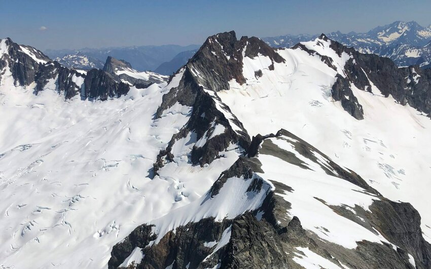 The Boston Glacier, left, viewed from Forbidden Peak, falls away from Boston Peak in the North Cascades. Boston Basin to the right. (Bill Lucia/Washington State Standard)