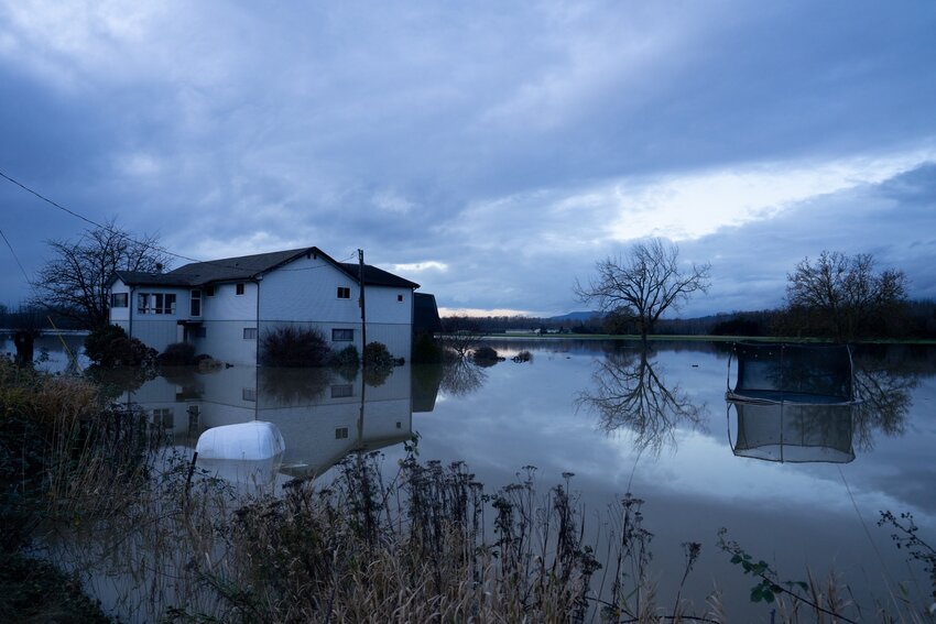 A house off Francis Road in Silver Lake, about a half hour outside of Concrete, still surrounded by floodwater on Dec. 17, 2025. (Photo by Eli Voorhies for Washington State Standard)