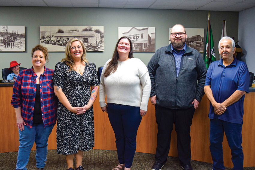 From left, Jennifer De Luz, Brittny Michaelson, Melissa Doughty, Jason Friend and John &ldquo;JJ&rdquo; Burke stand together following the oath of office Monday, Dec. 15. The group includes two newly sworn councilmembers and three re-appointed members.