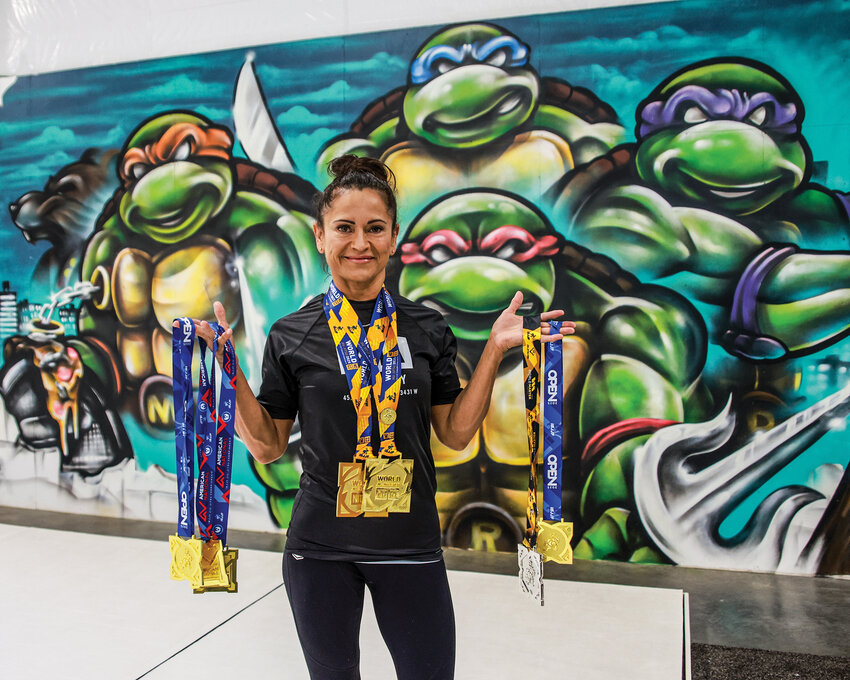 Battle Ground resident Virginia Mendez Rodeman poses with numerous gold medals she has won at the world stage of jiu-jitsu in recent years, with her two most recent coming by way of the 2025 IBJJF No-Gi Worlds from Dec. 11-13 in Las Vegas.