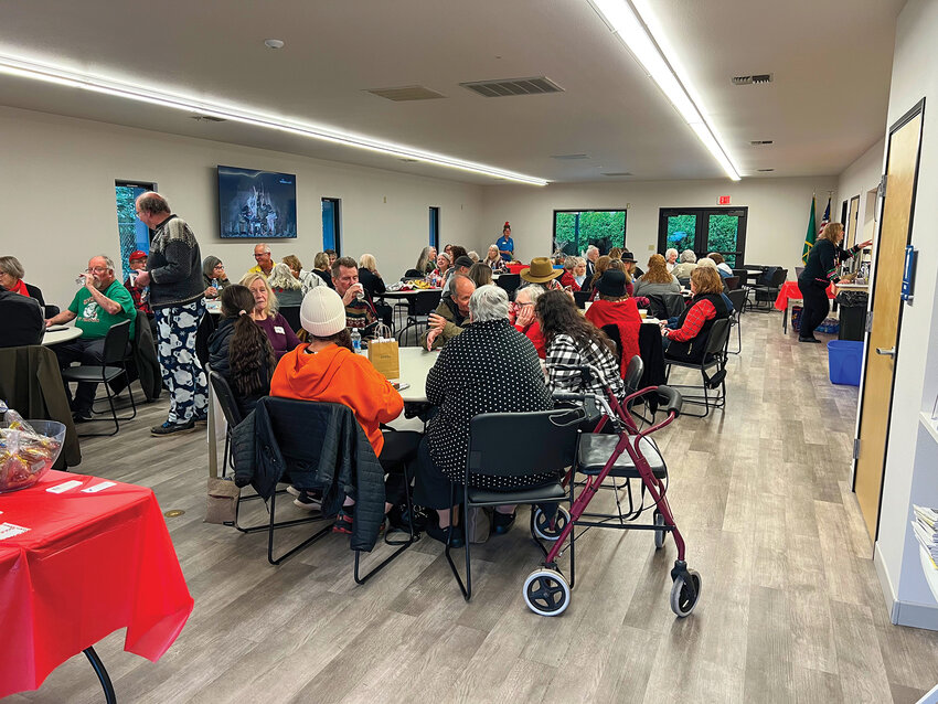 Seniors from across Southwest Washington socialize during a joint holiday social at the Battle Ground Senior Center on Wednesday, Dec. 10. Members of three North Clark County senior groups gathered to socialize, enjoy treats and collect donations for local families in need.