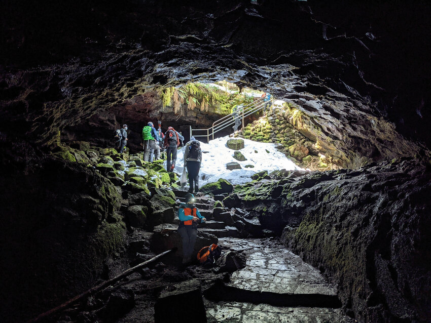 Visitors explore the Ape Cave on the south side of Mount St. Helens.