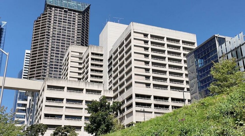 The King County Jail building is seen in downtown Seattle with surrounding high-rises in the background.