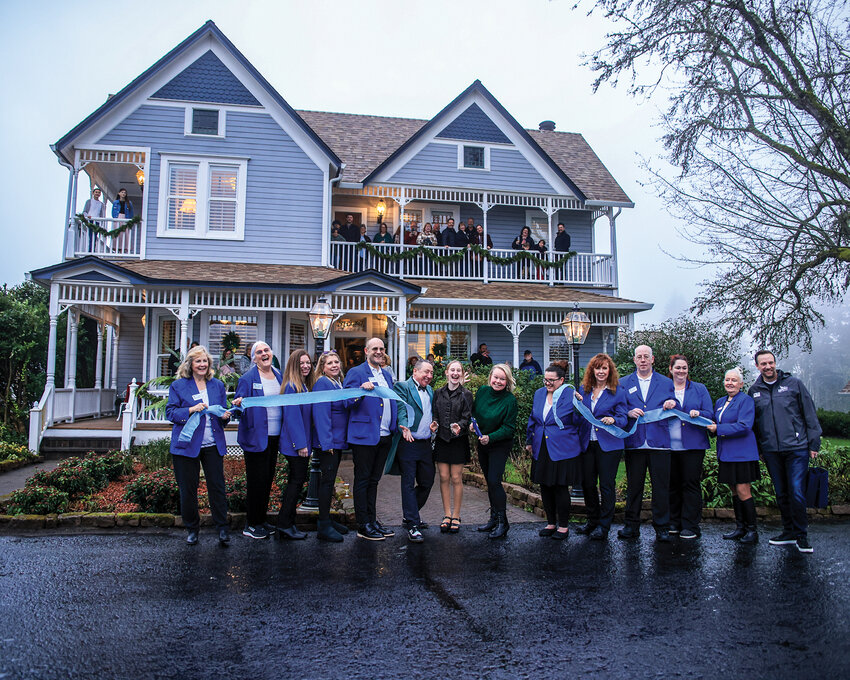 Bianca Benson cuts the ribbon while family, friends, the Blue Crew and Ridgefield Mayor Matt Cole are in attendance for the grand opening celebration of The Allen House Bed and Brunch on Friday, Jan. 2.