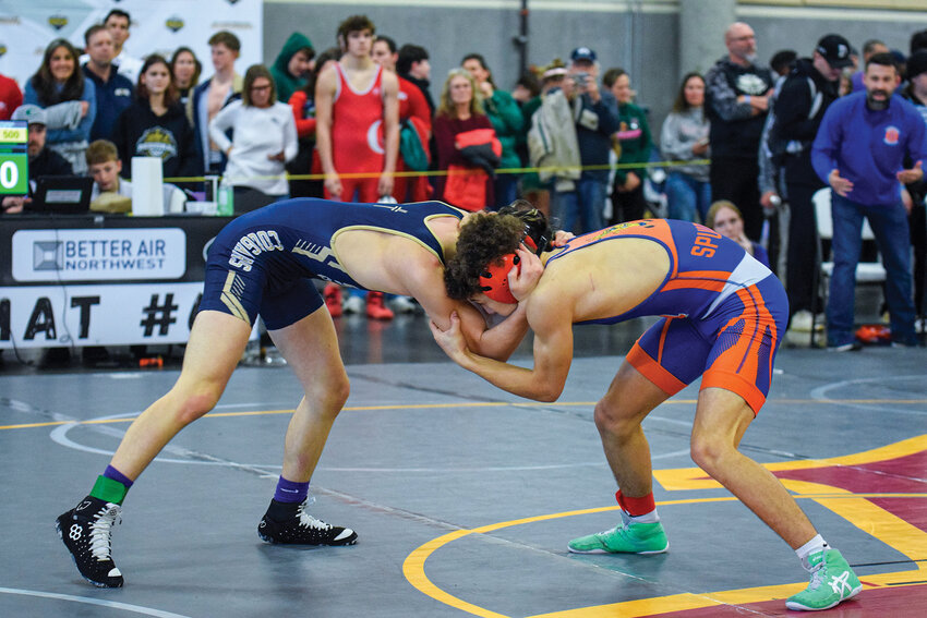 Ridgefield freshman Kolston Hulegaard and Seton Catholic sophomore Sam Brown square off at the start of their Champion Round 2 match in the 113-pound division.