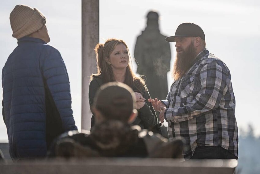 Carly Fritz and Brandon Figg speak with a homeless woman living in the park during a Destination Hope and Recovery and Centralia Police Department outreach event at George Washington Park in Centralia on Friday, April 4. Destination Hope and Recovery is the local Recovery Navigator Program provider for Lewis County.