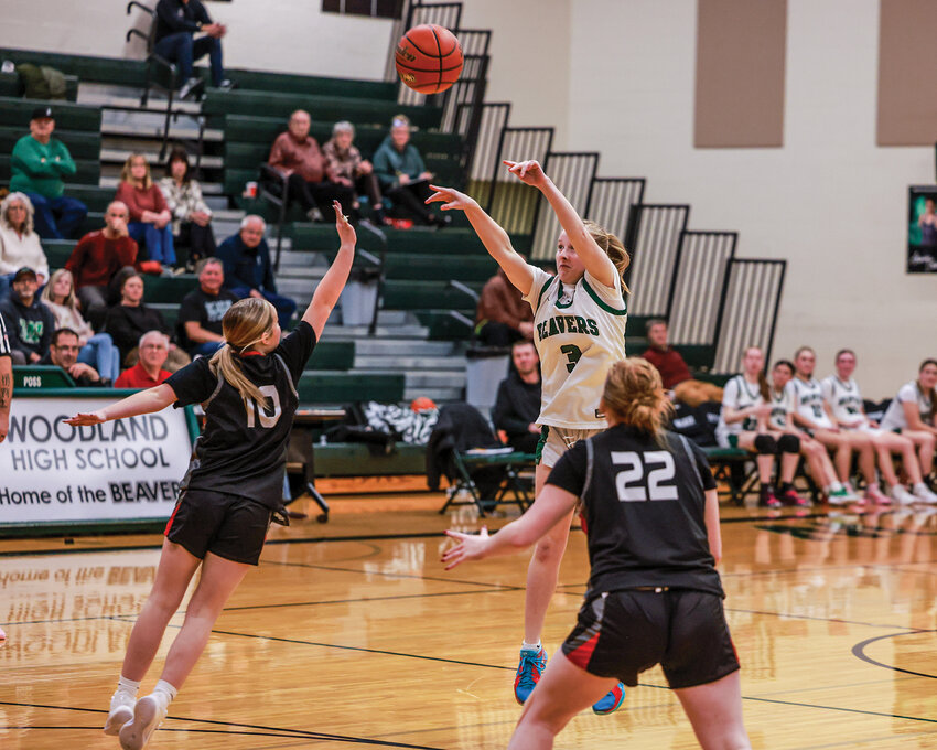 oodland sophomore guard Rally McReynolds hits a three pointer during the Beavers&rsquo; 61-14 win over R.A. Long High School on Tuesday, Jan. 6.