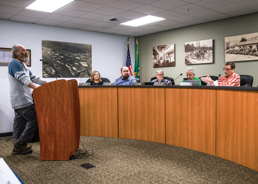 Woodland Mayor Todd Dinehart, right, responds to Rick Pettit, owner of Remnant Farms Feed and Supply store, after Pettit&rsquo;s public comment criticized the city&rsquo;s government and Dinehart during the Monday, Jan. 5, council meeting.