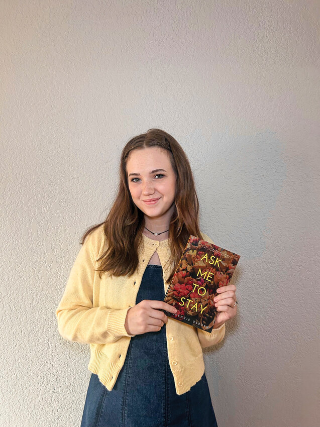2020 Battle Ground High School graduate Mackenzie Osborn holds her debut romance novel, &ldquo;Ask Me To Stay,&rdquo; which hit the Amazon book store on Dec. 5. In a month's time, her novel sold triple her first month sales goal.