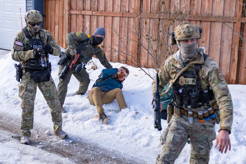 A U.S. Border Patrol agent holds down a pepper-sprayed bystander where Renee Good was shot and killed by Jonathan Ross, an ICE agent, in Minneapolis on Jan. 7.