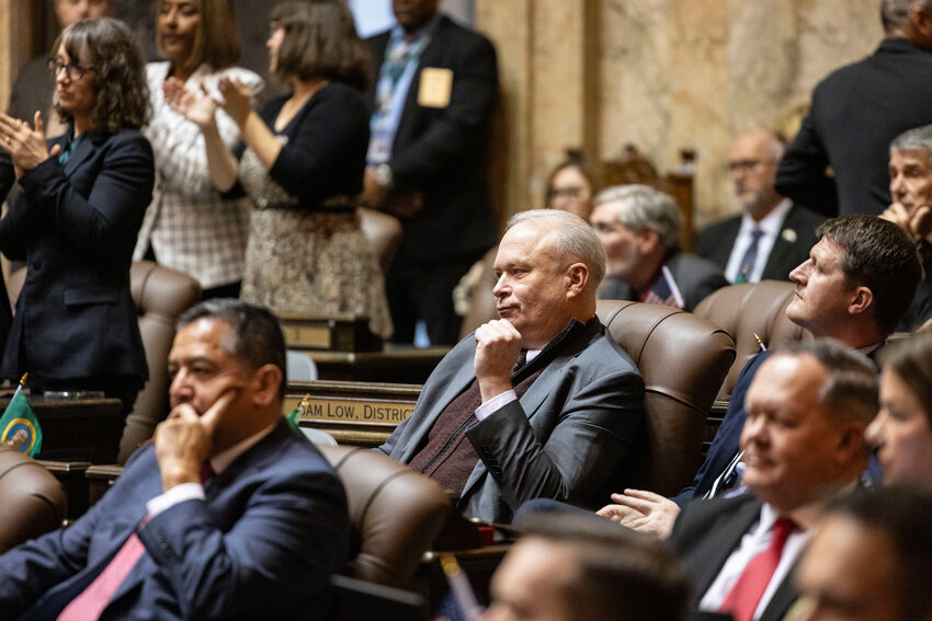 Rep. Jim Walsh, R-Aberdeen, stays seated during the State of the State address as Democrats stand to applaud Gov. Bob Ferguson at the Washington state Capitol in Olympia on Tuesday, Jan. 13.