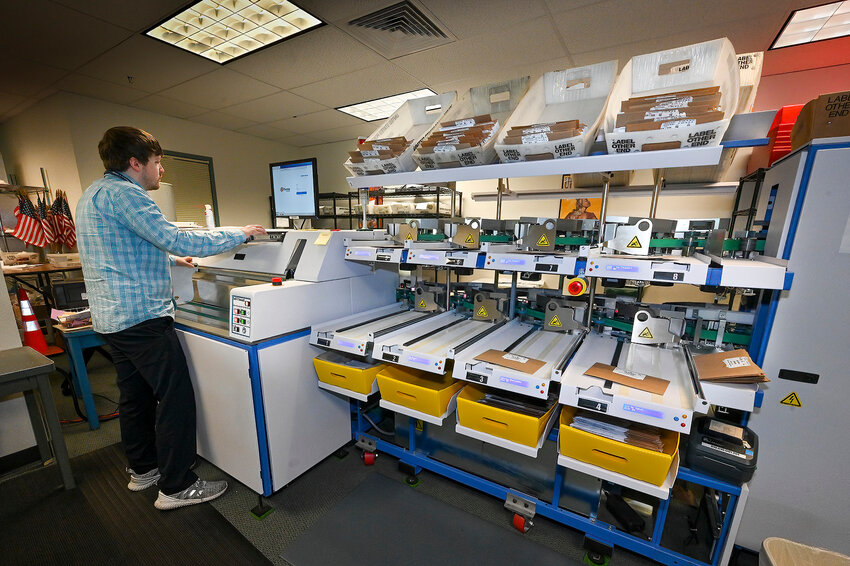 Ryan Patraw process ballots at the Marion County Clerk&rsquo;s Office in Salem on Monday, May 16. Each ballot goes through several steps before it is scanned to have the vote tabulated. (Photo by Ron Cooper/Oregon Capital Chronicle)