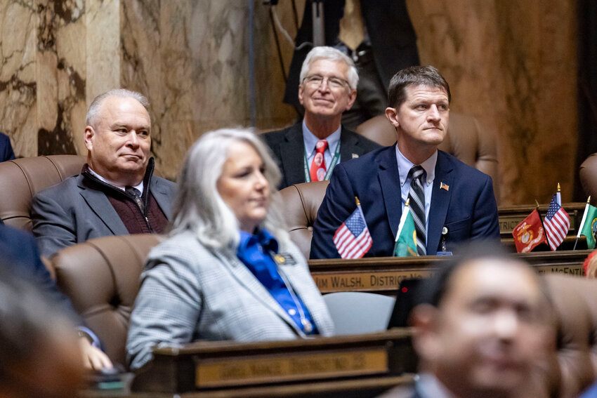 Rep. Jim Walsh, R-Aberdeen, and Rep. Joel McEntire, R-Cathlamet, listen as Lt. Gov. Denny Heck speaks in Olympia on Tuesday, Jan. 13.