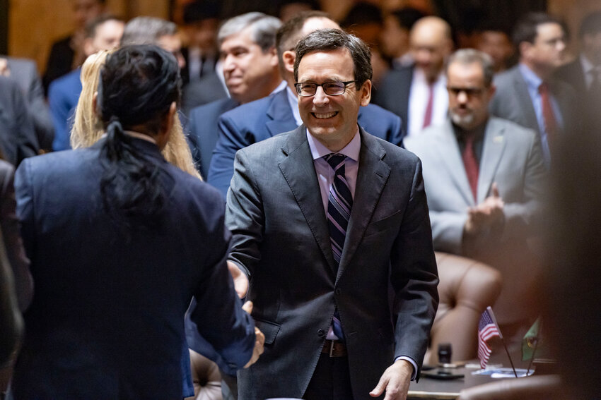 Gov. Bob Ferguson greets legislators before delivering the State of the State address in Olympia on Tuesday, Jan. 13.