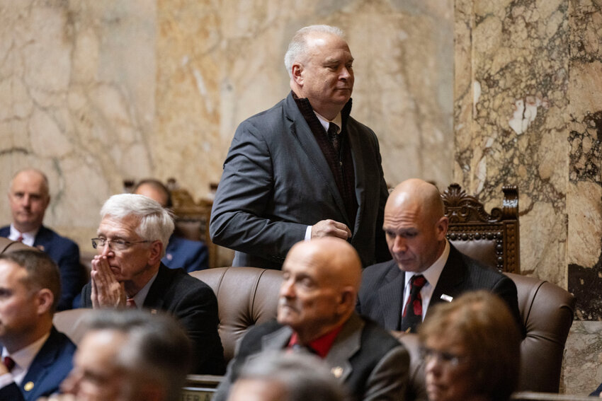Rep. Jim Walsh, R-Aberdeen walks off the chamber floor while Gov. Bob Ferguson delivers the State of the State address at the Washington state Capitol in Olympia on Tuesday, Jan. 13.
