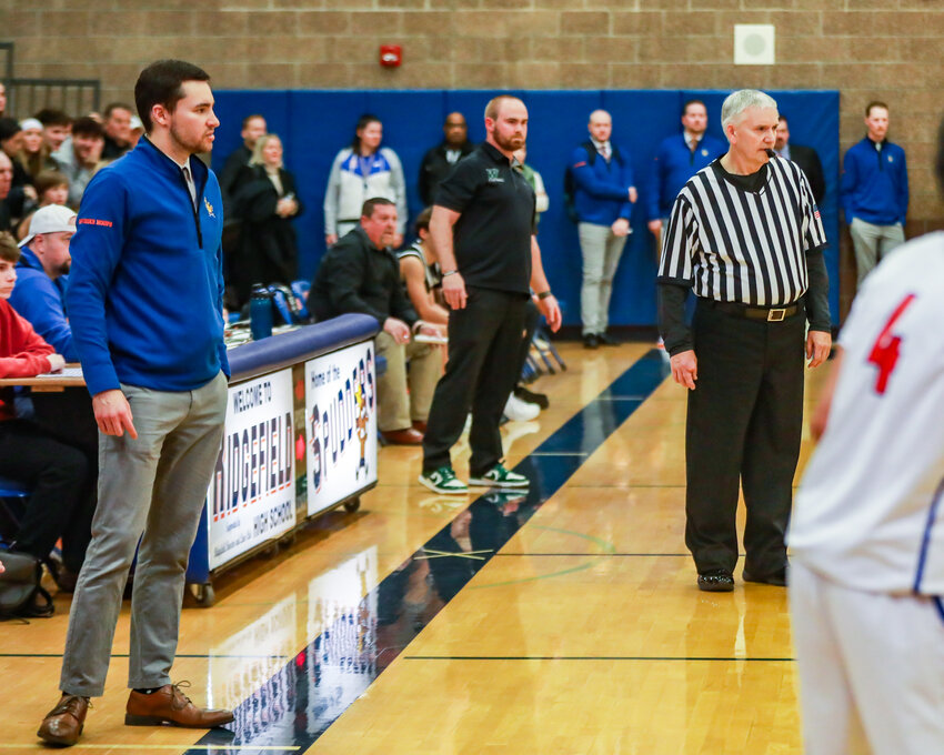 Ridgefield JV coach Tanner Slag, left, was surprised by his father, Jerome Slag, right, flying in from North Dakota to be a referee for the game on Thursday, Jan. 15.