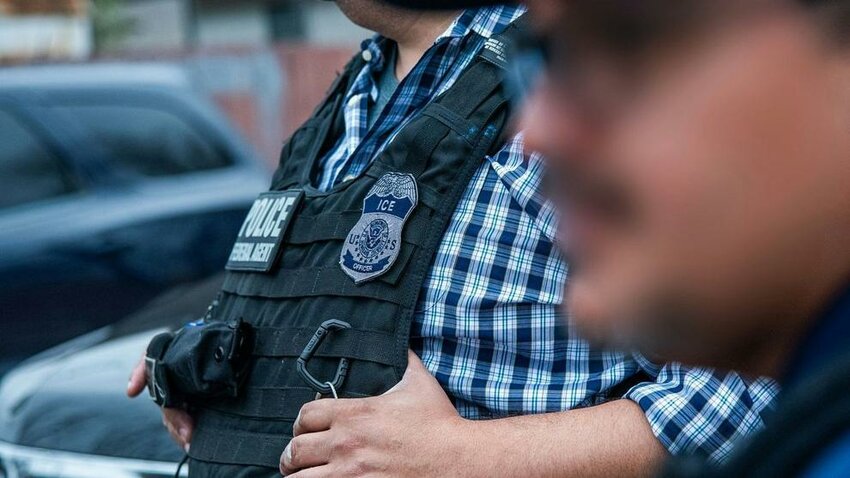 An ICE officer coordinates with officials during an enforcement operation in San Antonio on Feb. 5, 2025.