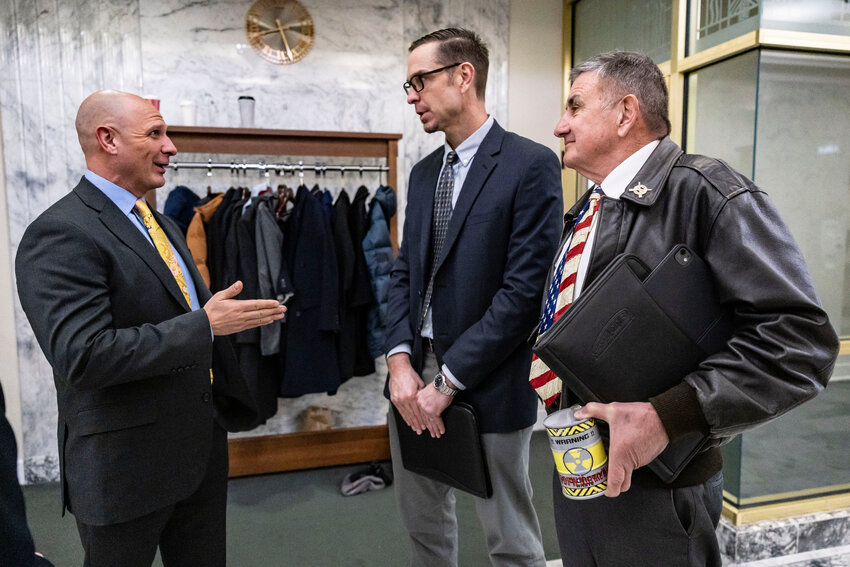 From the left, Rep. Peter Abbarno, R-Chehalis, talks to Centralia Public Works Director Andy Oien and Centralia Mayor Norm Chapman following a public hearing on House Bill 2343 on Thursday, Jan. 22, in Olympia.