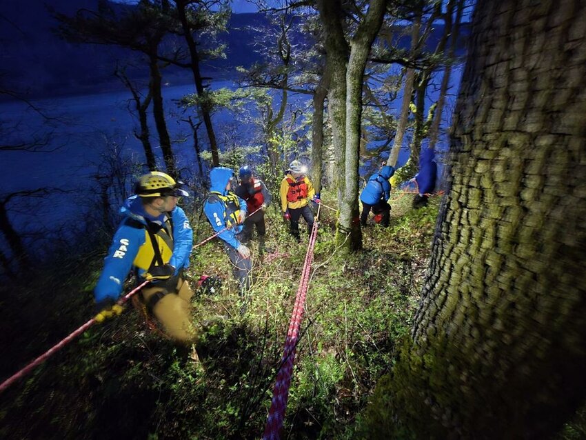 Skamania County Sheriff&rsquo;s Office Search and Rescue volunteers lower themselves down a 40-foot cliff for a body recovery on April 2, 2025.