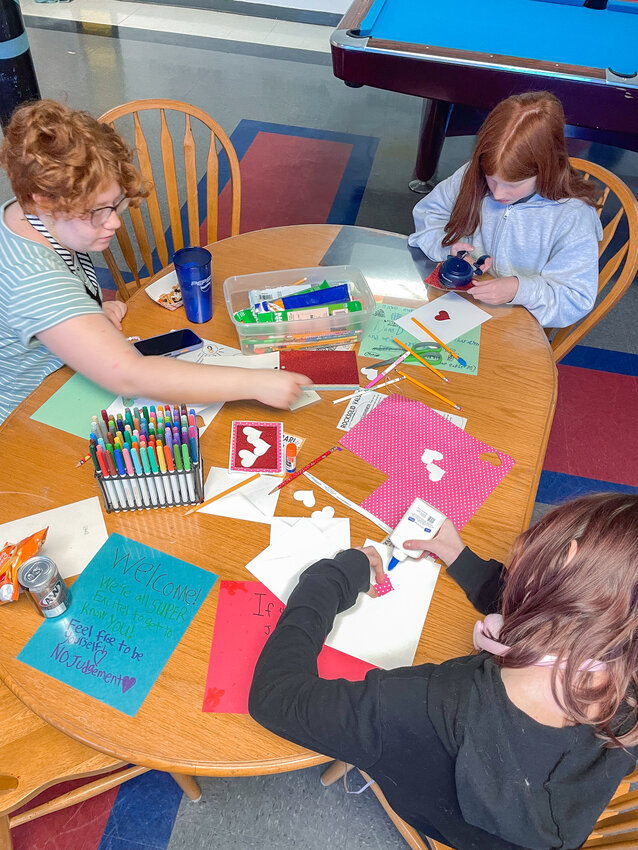 Teens from Rocksolid Community Teen Center sit together decorating Valentine&rsquo;s Day cards during a card-making session last week. The cards will be delivered to residents at Mallard Landing and Creekside Memory Care as part of a community-wide project organized by Battle Ground Senior Citizens Inc.