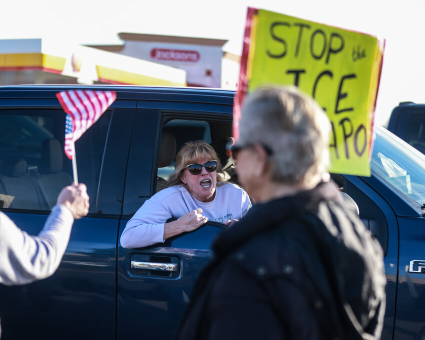 A woman in a passing car yells at protesters during a demonstration opposing ICE and the Trump administration in Battle Ground on Tuesday, Jan. 20.