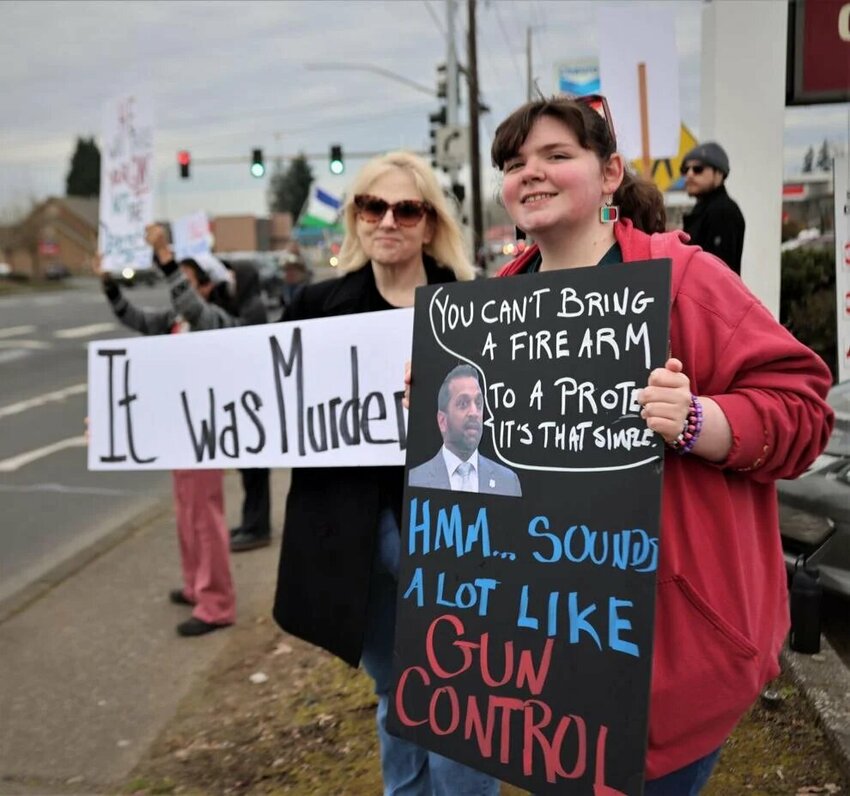 Jennifer Zacher, 57 and on the left, and her daughter Elizabeth Zacher, 23, both of Longview, hold signs on Tuesday, Jan. 27 at a Longview pro-gun rally. "You'd be surprised how many liberals are responsible gun owners," Jennifer Zacher said.