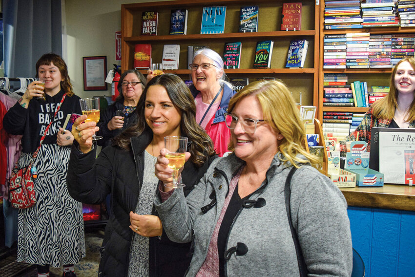 A crowd of guests raises glasses during a toast at Literary Leftovers on Thursday, Jan. 29. The social marked the used bookstore&rsquo;s 25th anniversary and celebrated its long-standing role in the Battle Ground community.