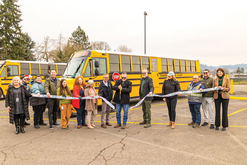 School leaders and partners of the KWRL Transportation Cooperative serving Kalama, Woodland, Ridgefield and La Center school districts celebrate 14 new electric school buses with a ribbon-cutting ceremony on Tuesday, Jan. 27.