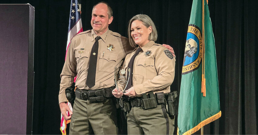 Clark County Sheriff John Horch, left, stands with the department&rsquo;s Deputy of the Year, Amanda Nohrenberg.