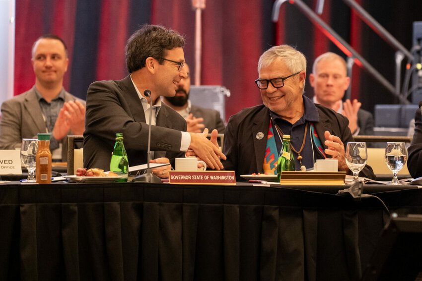 Washington Gov. Bob Ferguson, left, shakes hands with Cowlitz Indian Tribe Chairman Bill Iyall after signing an executive order to improve the state&rsquo;s relations with tribal governments on Oct. 22, 2025. (Photo courtesy of Washington governor&rsquo;s office)